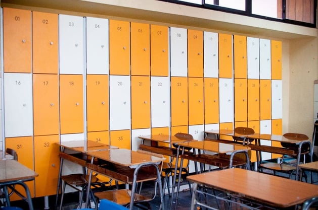 Fundermax Max Compact Interior panels applied on lockers in orange and white decors with benefits of durability, flexibility and versatility