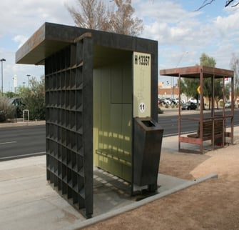 Digitally printed panel with bus information at a university as well as a covered waiting area for those using the bus