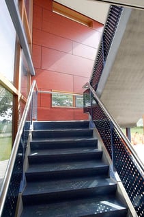 Examples of High-Traffic Spaces Where HPL Cladding Thrives - School Stairwell