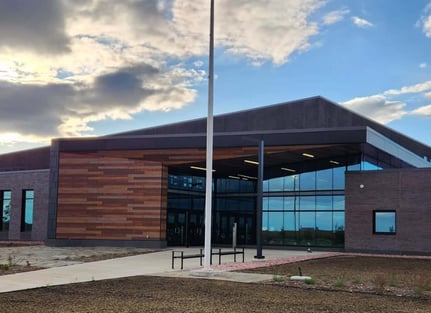 Distanced view of the National Guard Readiness Center featuring Fundermax phenolic panels in alternating woodgrain decors