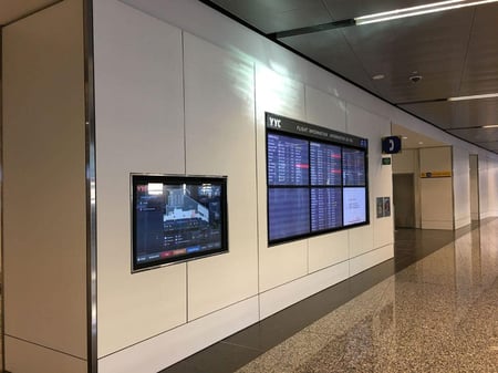 Examples of High-Traffic Spaces Where HPL Cladding Thrives - Airport Hallway with TVs