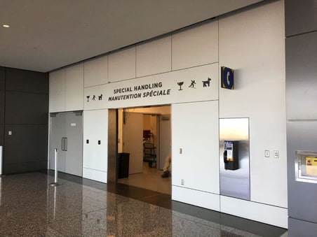 Digitally printed phenolic panels in an airport indicating where special handling is