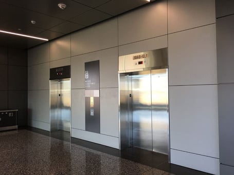 example of Fundermax's Max Compact Interior Plus phenolic panels in an airport elevator 