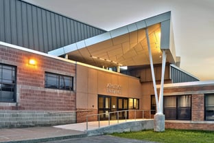 The other side of the building with a mirrored entryway to the athletics area of Sodus High School