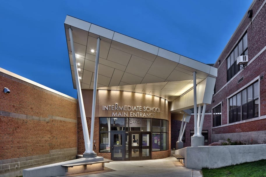 Front entryway of Sodus High School in New York lit up showcasing Fundermax's HPL panels.