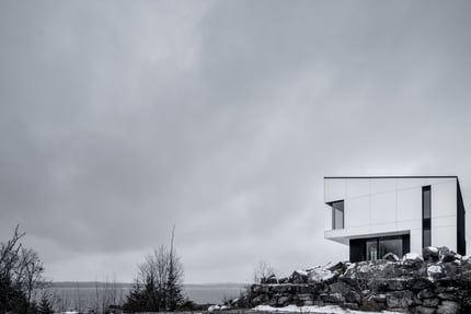 Residential home in Canada using white exterior phenolic panels and a concealed fastener.