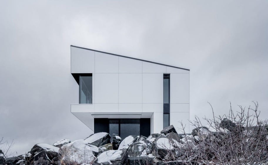 Shift House residential building in Canada blending in with it's environment due to Fundermax exterior phenolic panels.