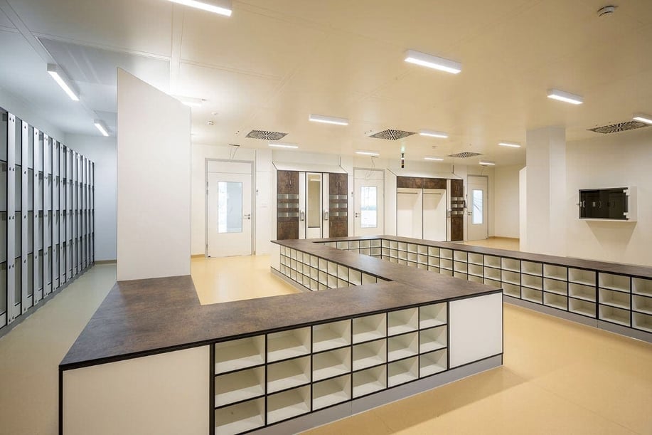 Fundermax phenolic panels in locker and furniture applications in White, Patina Bronze, and Aluminum at the MED-EL GmbH Medical Office Building Innsbruck, Austria