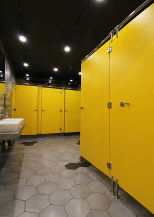 example of Fundermax's Max Compact Interior Plus phenolic panels in a bathroom partition and counter