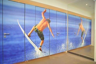 Individualdecor digitally printed design of a wake surfer on phenolic washroom partitions
