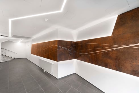 Custom digitally printed hallway wall lining panels in a woodgrain with with added branding and imagery