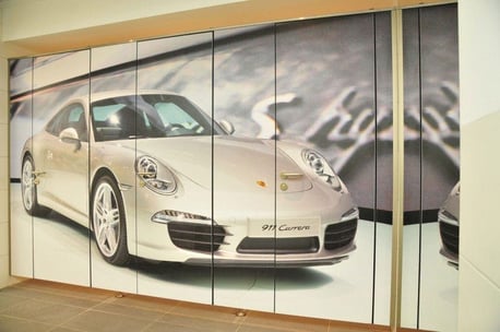 Custom bathroom partition with an image of a porche