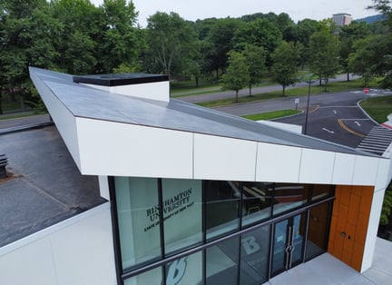 Side image of the SUNY Binghamton Welcome Center with sleek white phenolic soffits