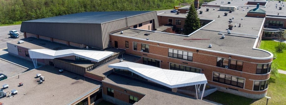 High view of the finished application on Sodus High School using Fundermax in a unique roofing application for added protection.