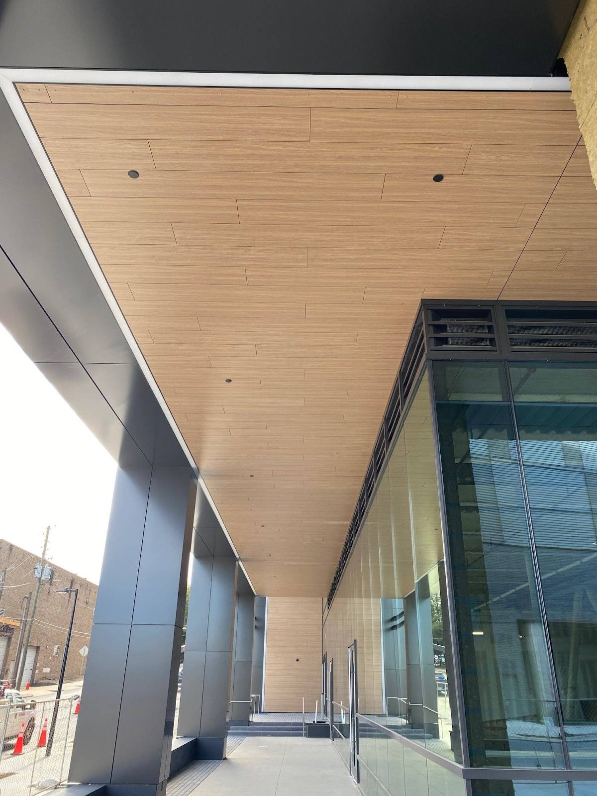 Fundermax phenolic panels as soffits paired with metal panels.